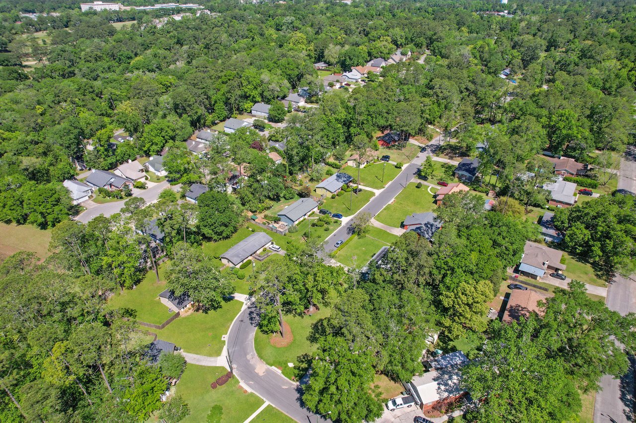 An aerial view focusing on a specific area within the Old St. Augustine neighborhood, showcasing the layout of houses and greenery.