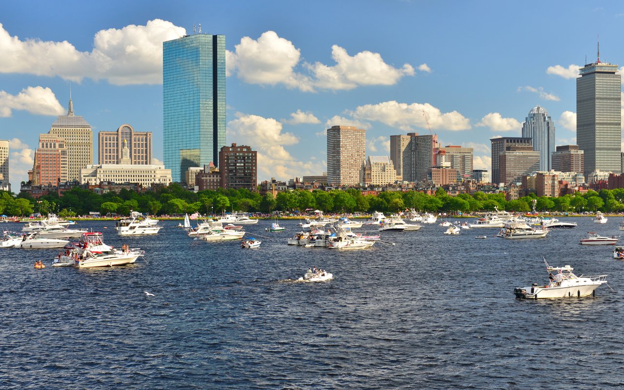Boston Seaport District waterfront on a luxury summer evening with harbor views