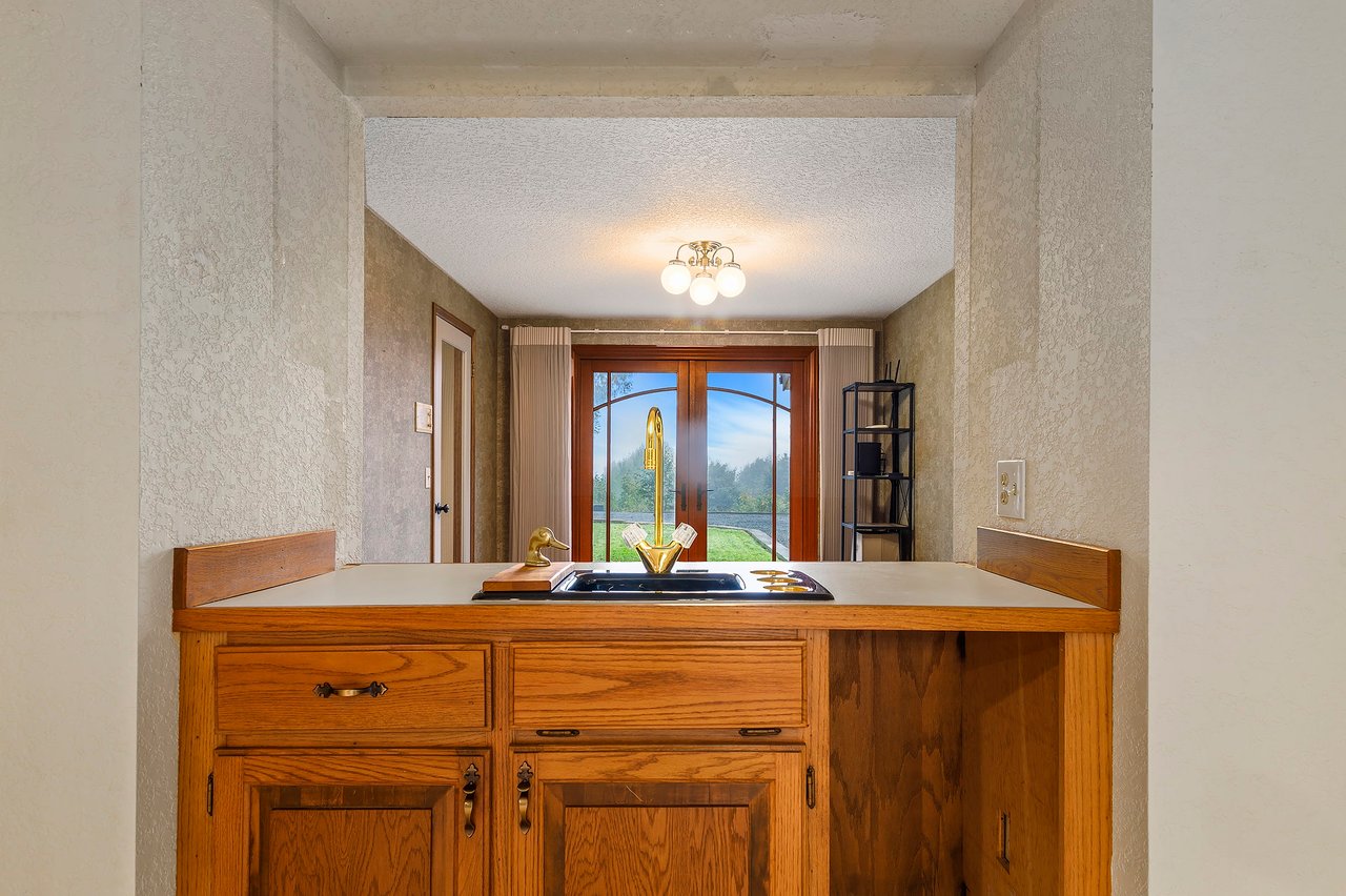 Between the office, living room, and kitchen, you'll find a convenient small bar sink area. It's a versatile space perfect for entertaining, offering easy access to refreshments for guests in various parts of the home.