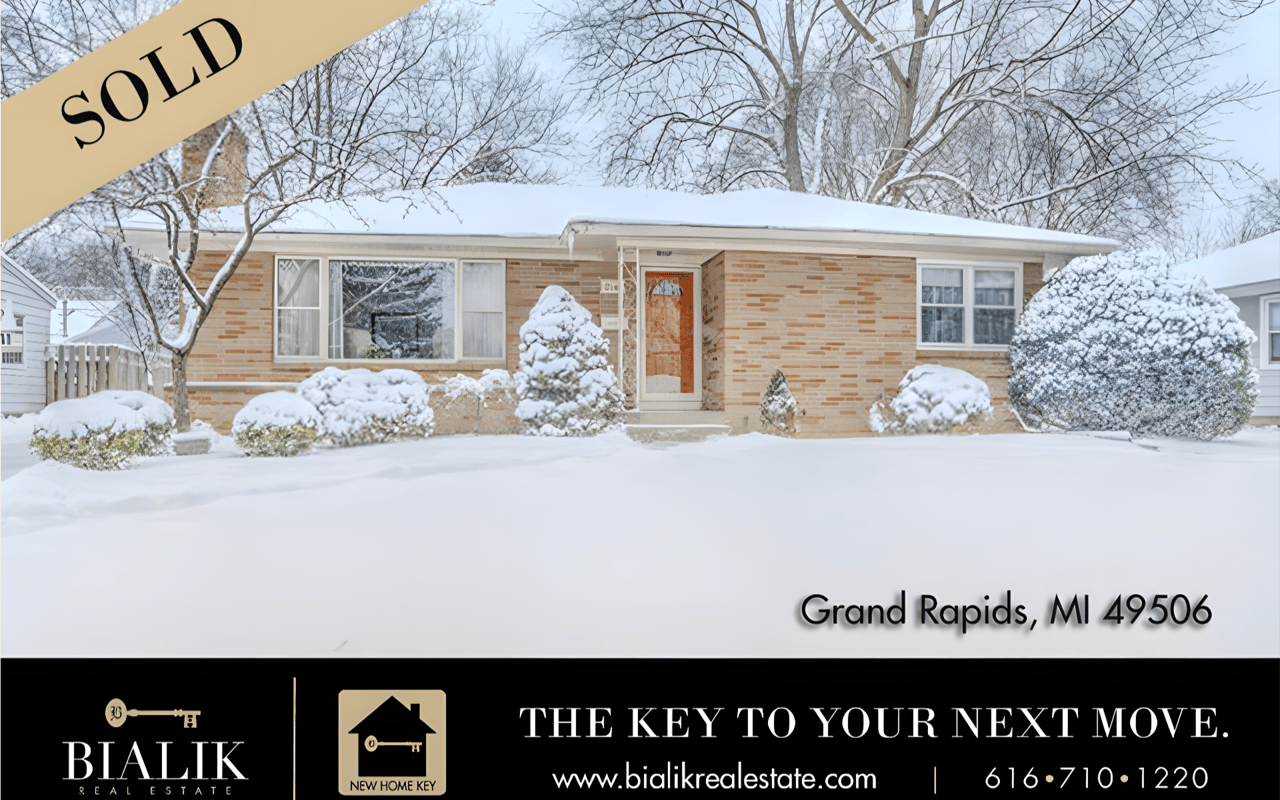 Brick ranch home sold in winter, with snow-covered landscaping and a SOLD banner.