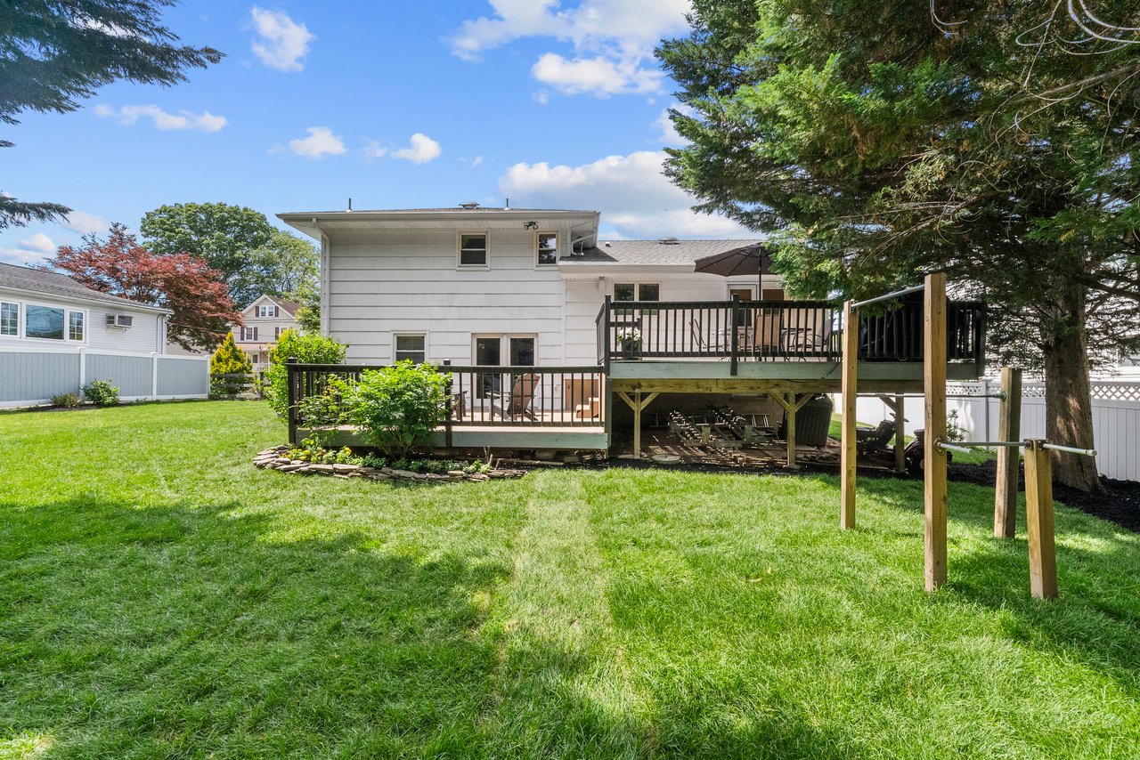 Spacious private fenced backyard with deck and play area at 322 Scharer Ave, Northvale, NJ.