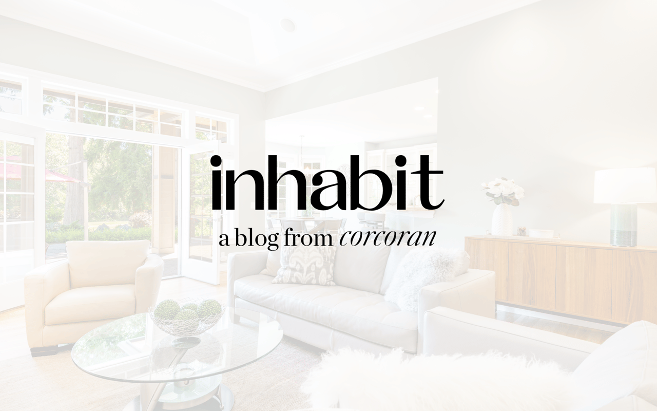 Bright living room with white furnishings and large windows, overlaid with Inhabit blog branding.