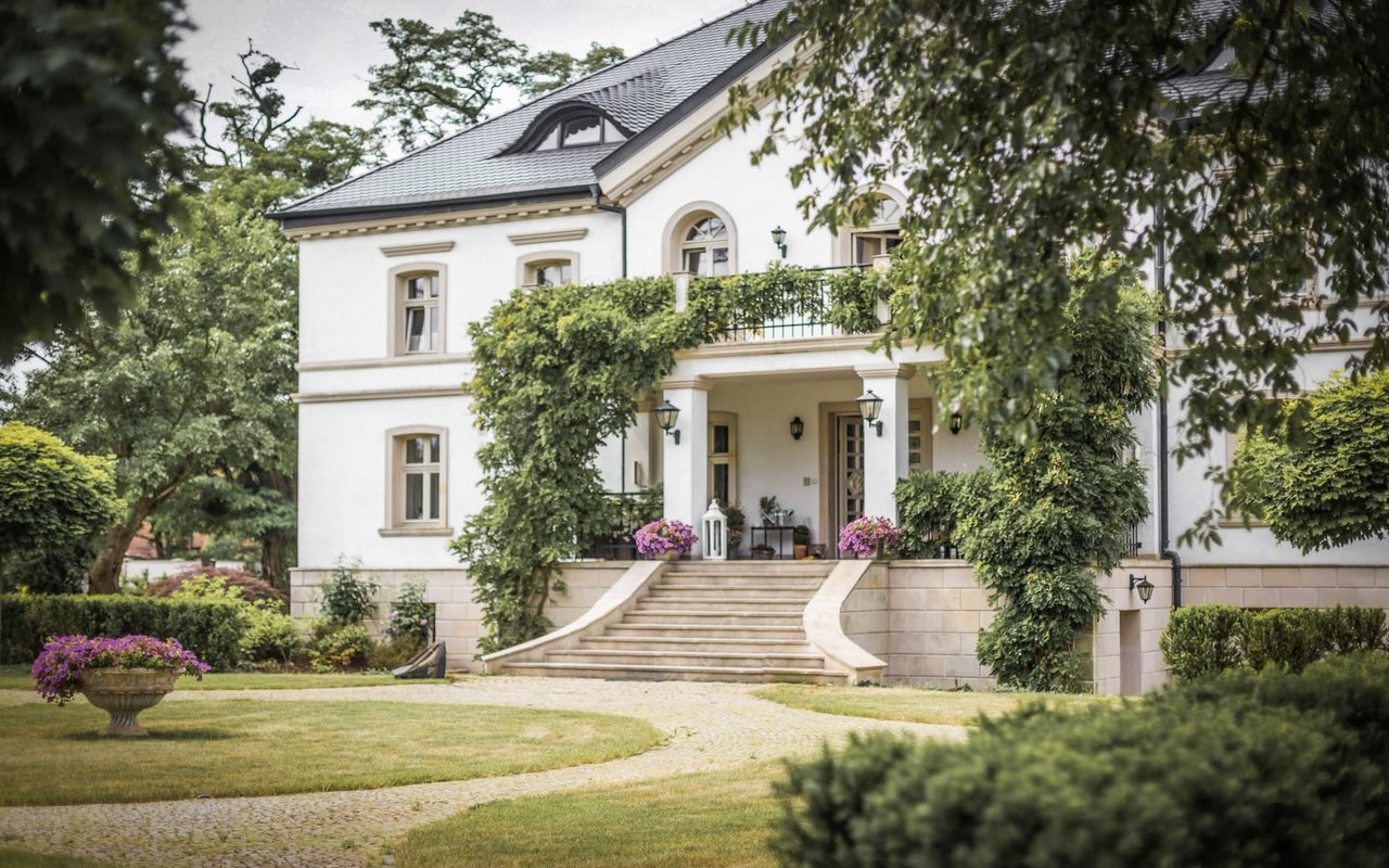 white luxury house with large front lawn