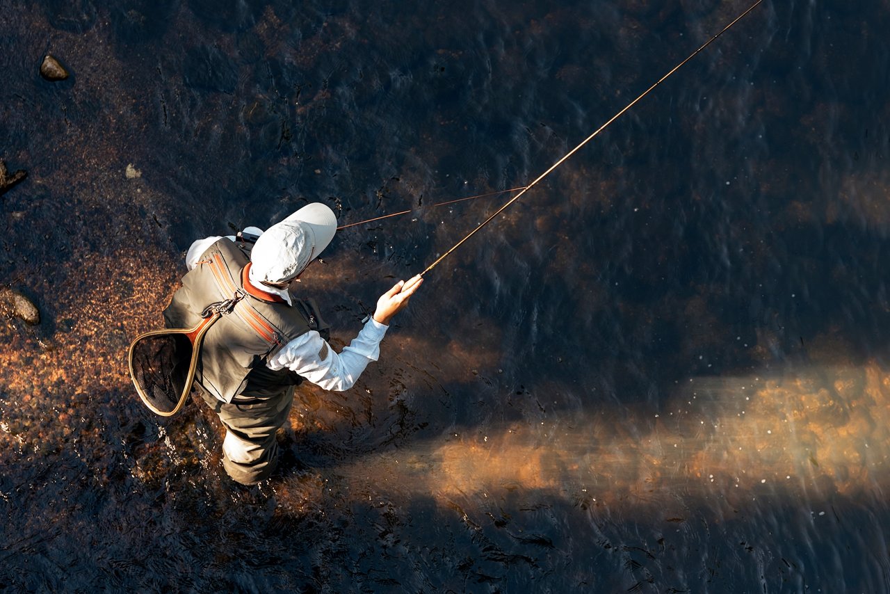 fly fisherman in shallow water
