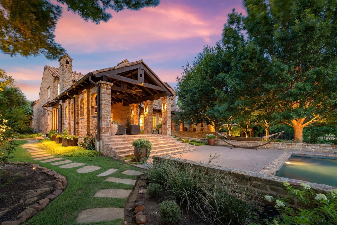 A large house with a covered patio and a pool