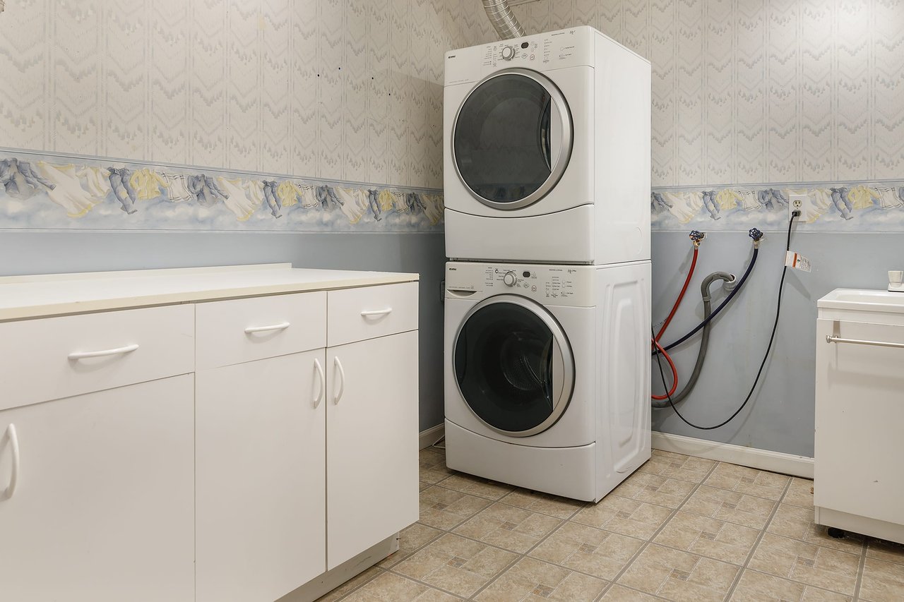 Effortlessly manage laundry tasks in the spacious downstairs laundry room, offering both convenience and ample space for efficient daily chores.