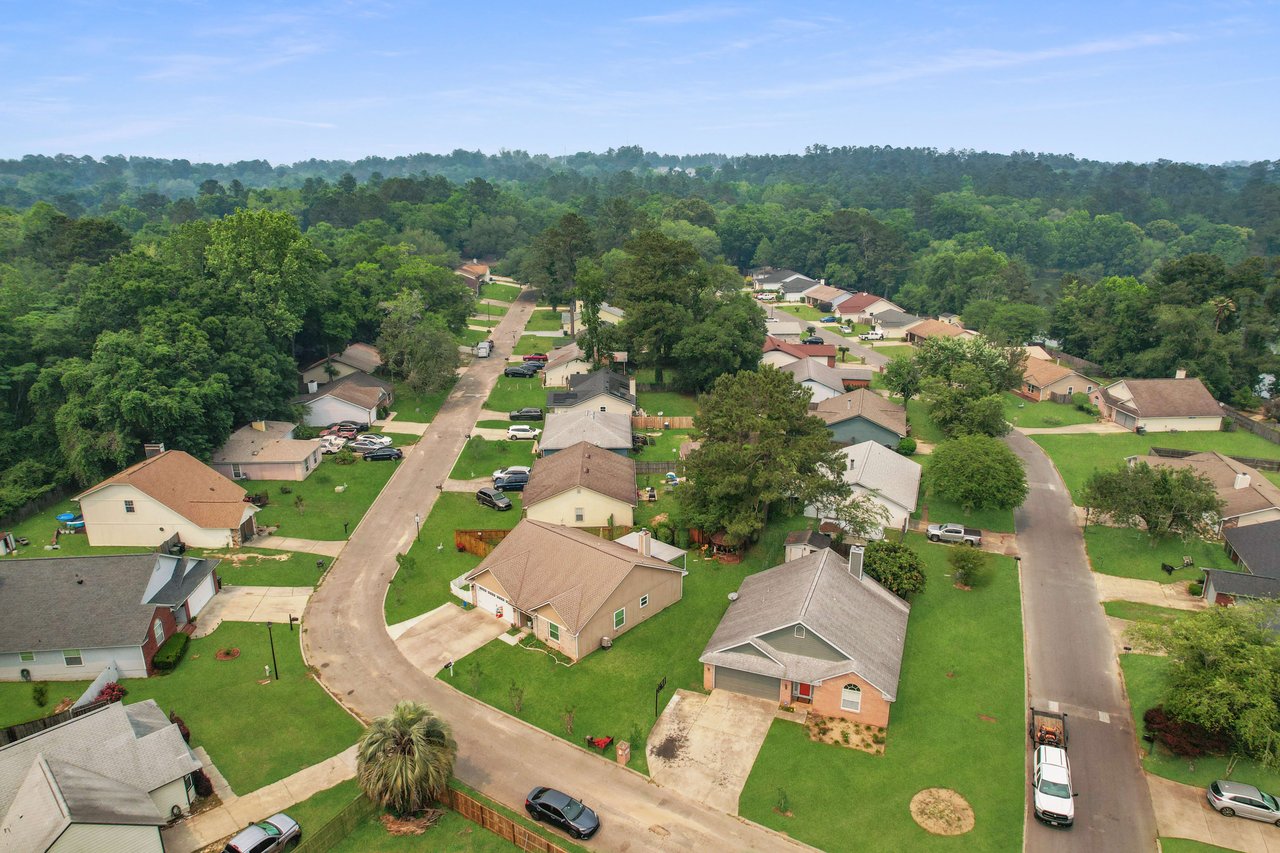 A similar aerial view of Hartsfield Village, showing houses and streets, with a different angle providing a broader perspective of the community.