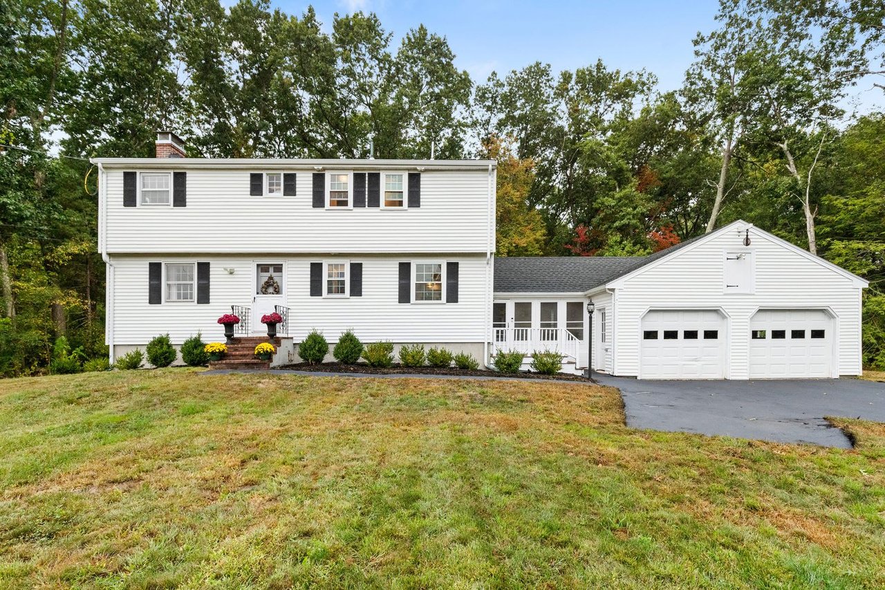 White house with black shutters and a garage