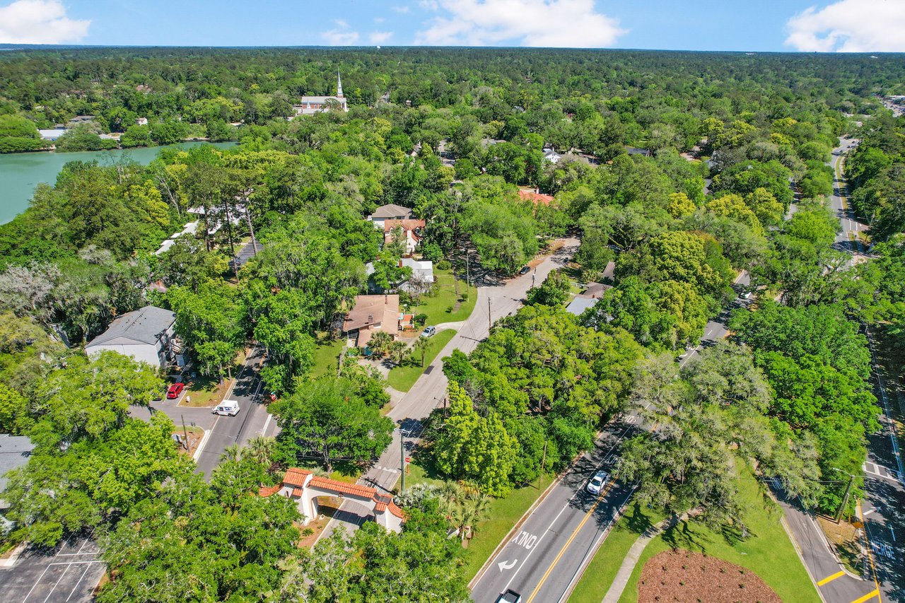 An aerial view of the Los Robles neighborhood, showing houses, streets, and abundant greenery.