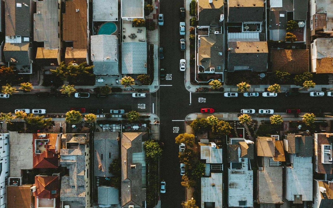 Aerial view of downtown community across roads with cars