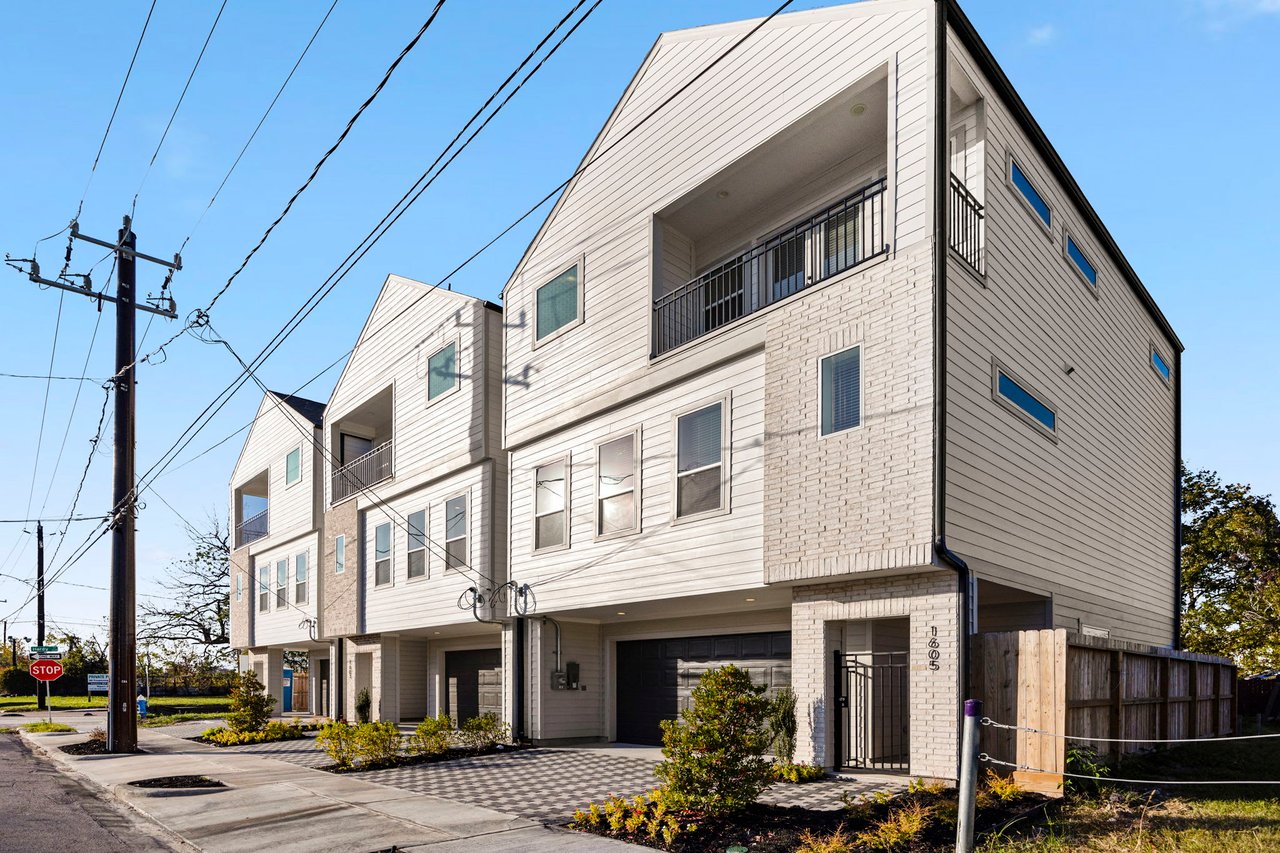 a row of 3 townhomes by Oracle City Homes