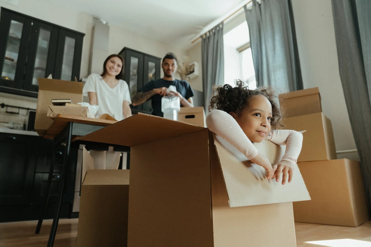 family having fun moving in to a new home