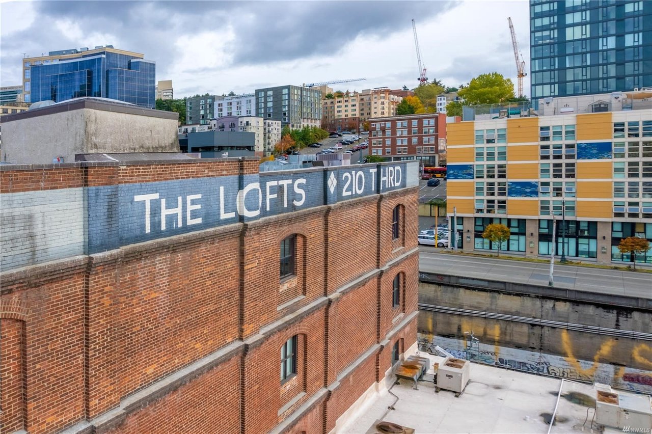 An elevated view of "The Lofts" sign painted on a brick building.