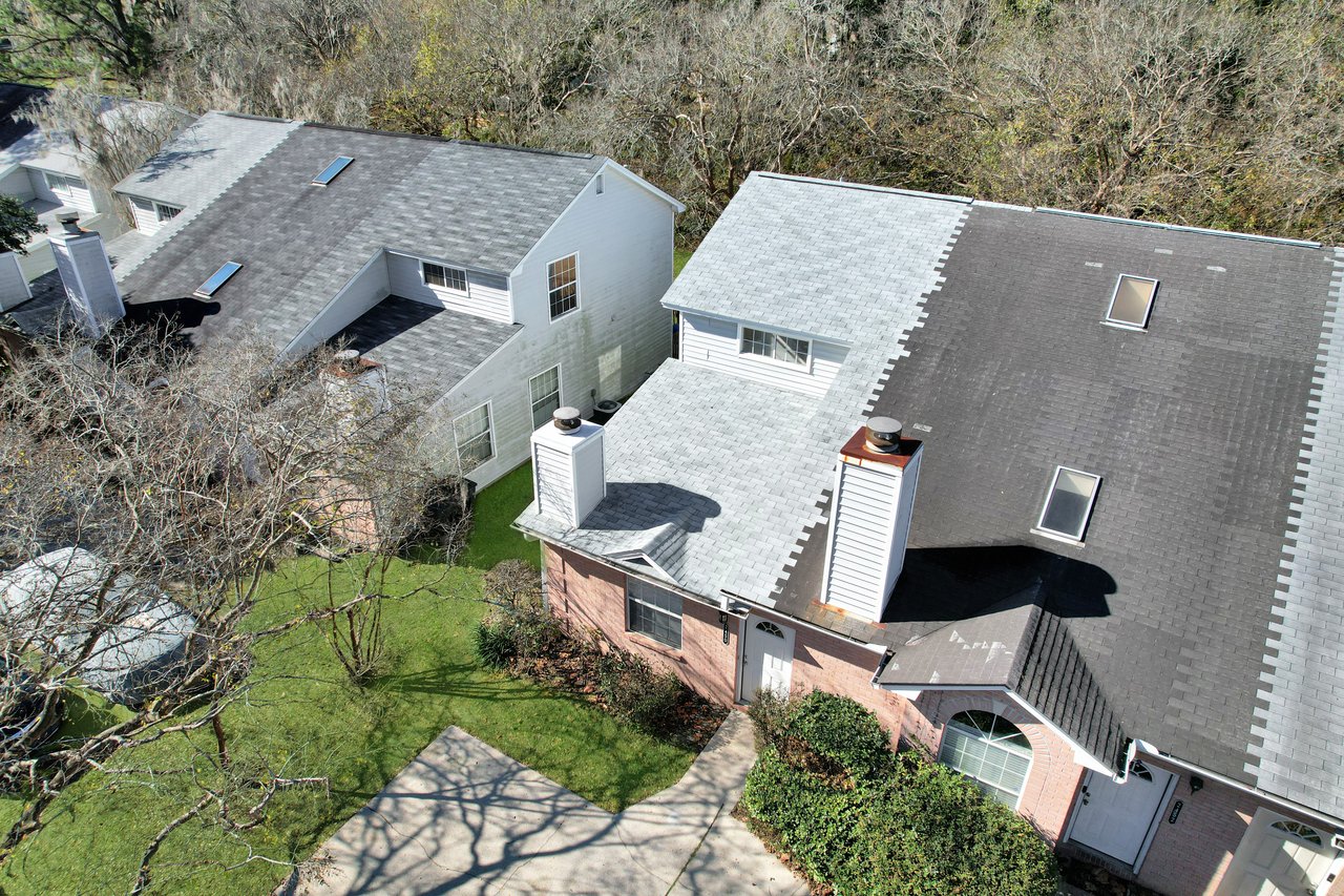 A house featuring a gray roof, showcasing a simple yet elegant architectural design.