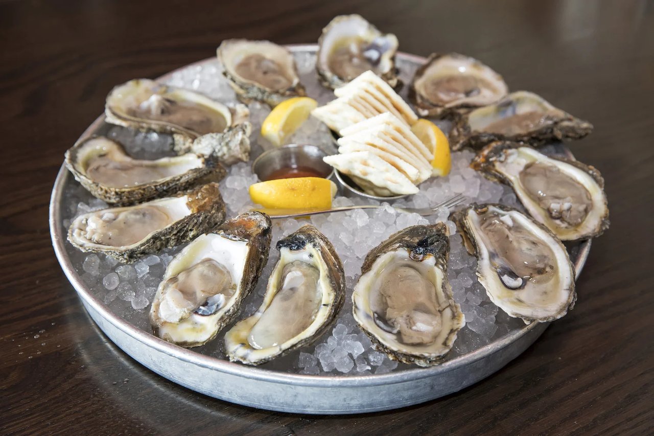 Oysters on crushed ice with lemon, crackers, and cocktail sauce.