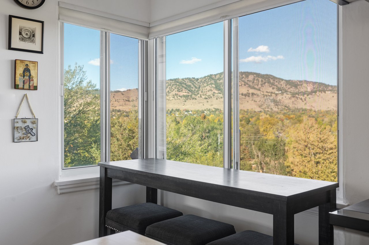 Corner window seating area at 2003 Balsam Drive with a counter-height table and open foothill views