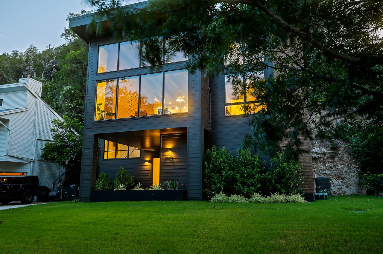 Twilight front elevation of the modern two-story Lake Austin waterfront residence built by Pecan Valley Custom Homes and designed by Kelley Design Group, 2403 Big Horn Drive, Austin.