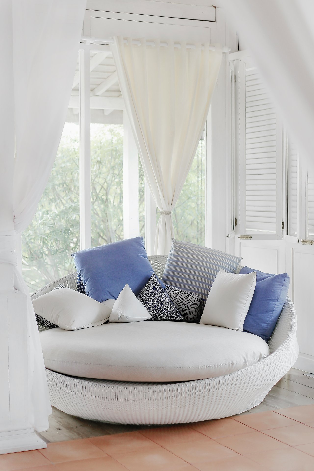 Clean chair with pillow beside the window