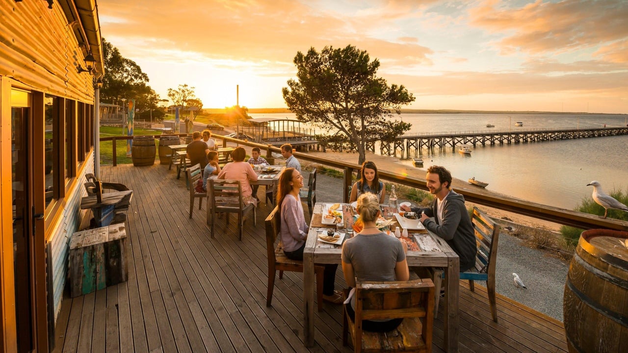 Friends enjoying authentic Italian food together at a beautiful Tampa Bay restaurant during sunset.