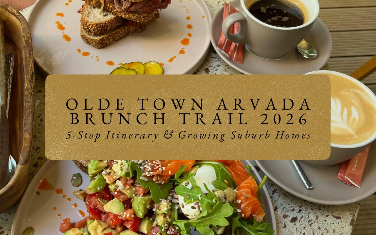 Bustling Olde Town Arvada street scene with brunch patrons at outdoor tables, historic buildings and American flags.