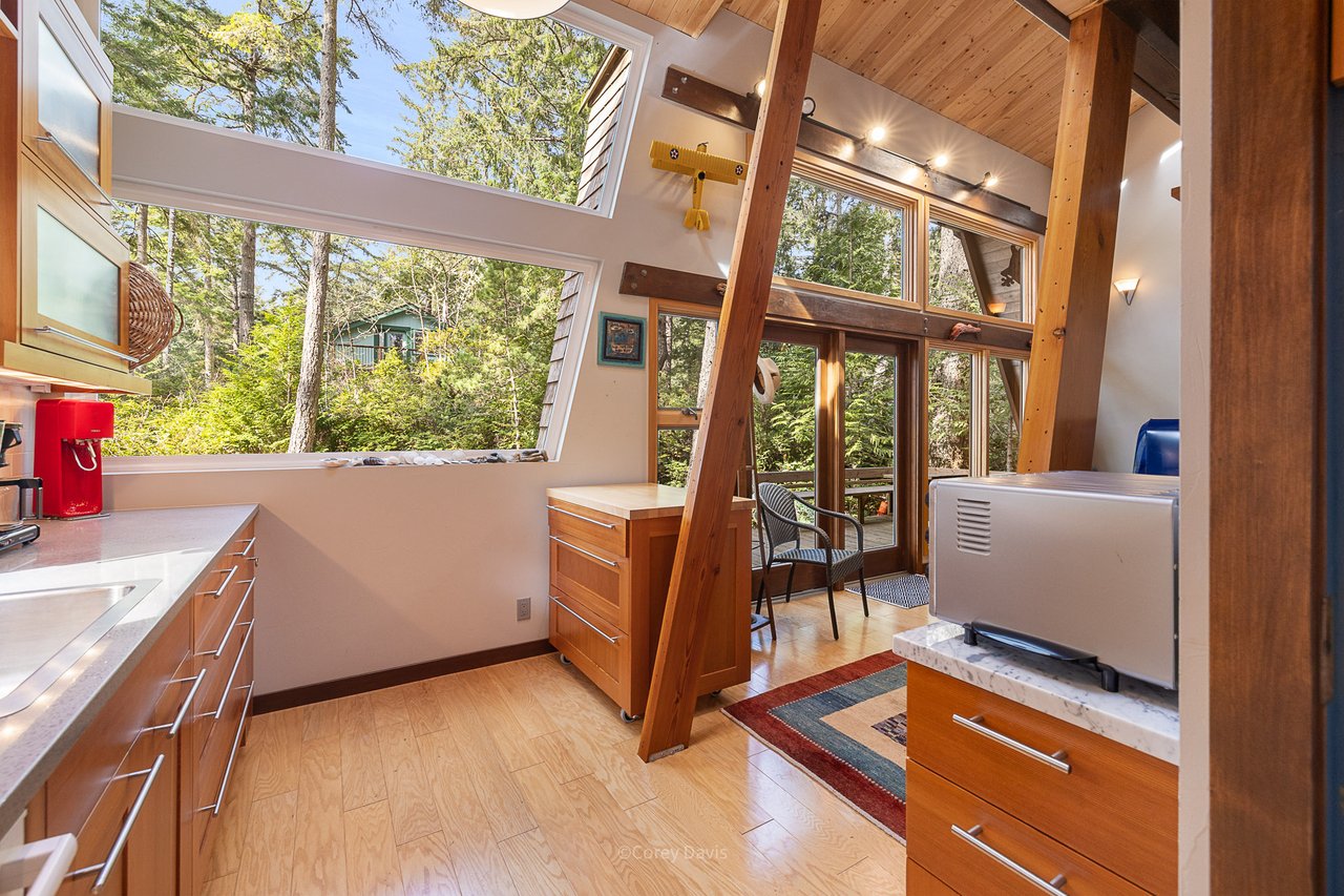 Sold beach cabin at 275 Ocean Ave in Manzanita, Oregon, represented by Meadow Davis of Home + Sea Realty, with wooded privacy, custom details, and beach access nearby.