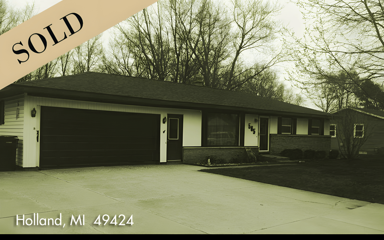 Single-story ranch home in Holland with a wide attached garage and a SOLD banner.