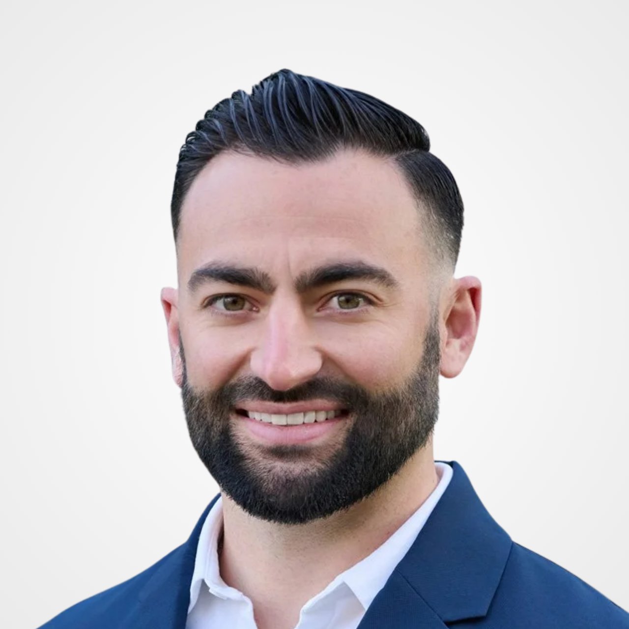 Chris Connolly, smiling in a navy suit against a plain light background.