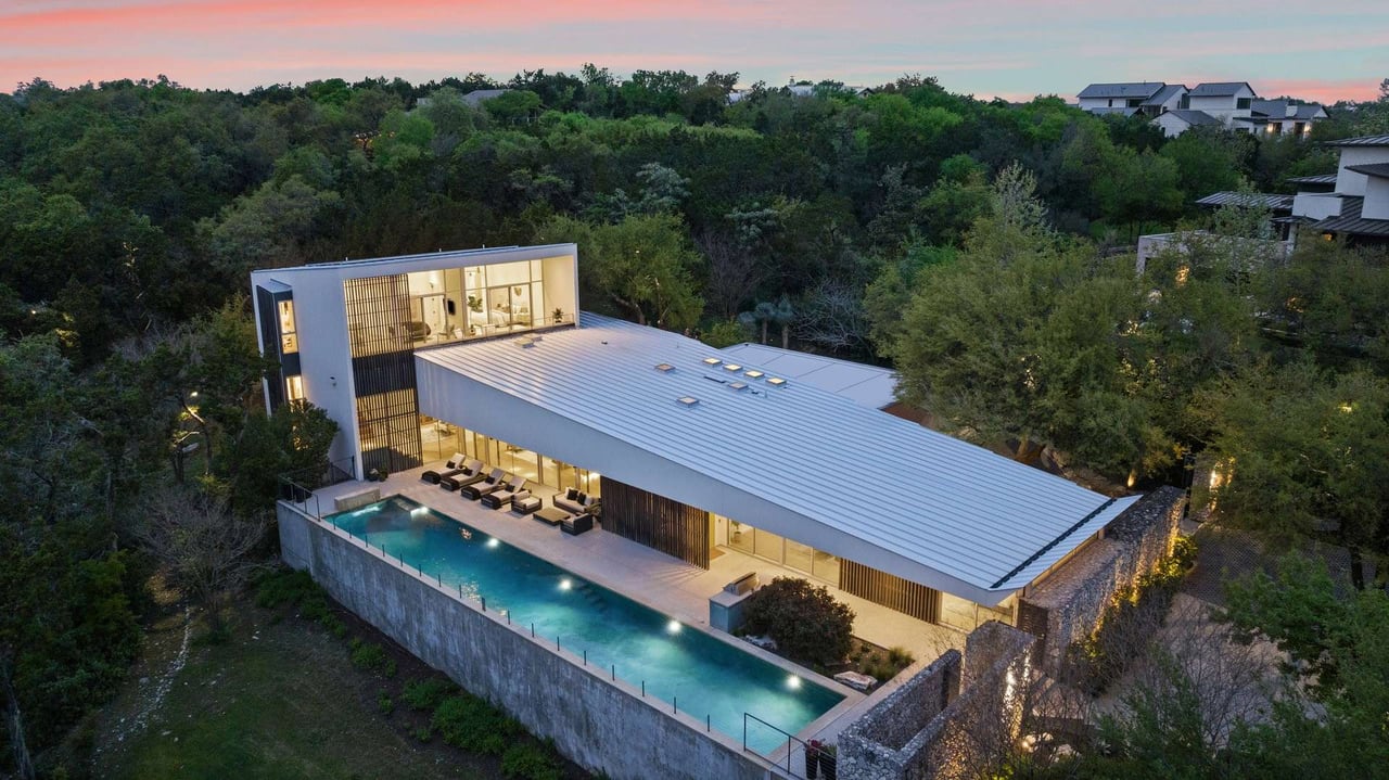 Twilight aerial view of Westlake luxury home in 78746