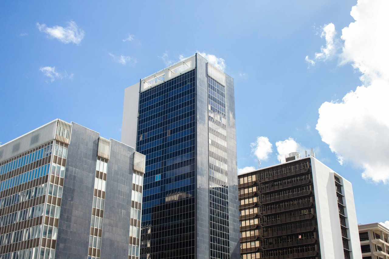 Modern office buildings with glass facades in Hato Rey, Puerto Rico, set against a clear blue sky.