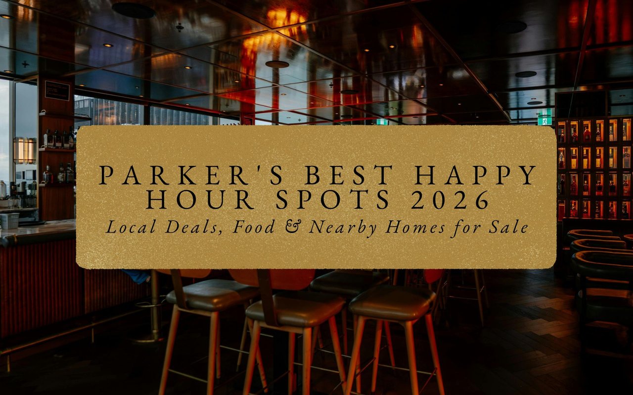 Cozy bar interior in Parker Colorado with neon 'Happy Hour' sign, patrons toasting glasses amid wooden tables.
