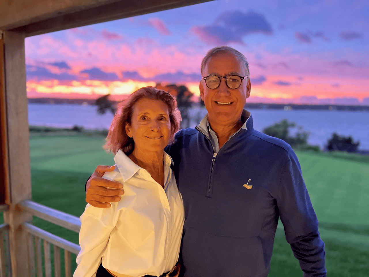 Nanci Borde’ and Paul Borde’ together on a deck at sunset.