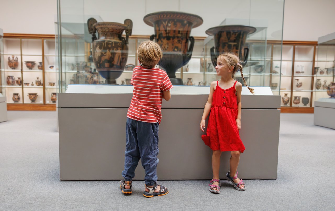 Kids exploring pottery exhibits at a Denver museum during a free admission day