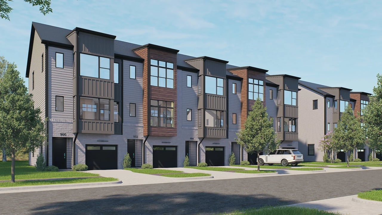 Architectural rendering of modern three-story townhomes with private garages along a landscaped street.