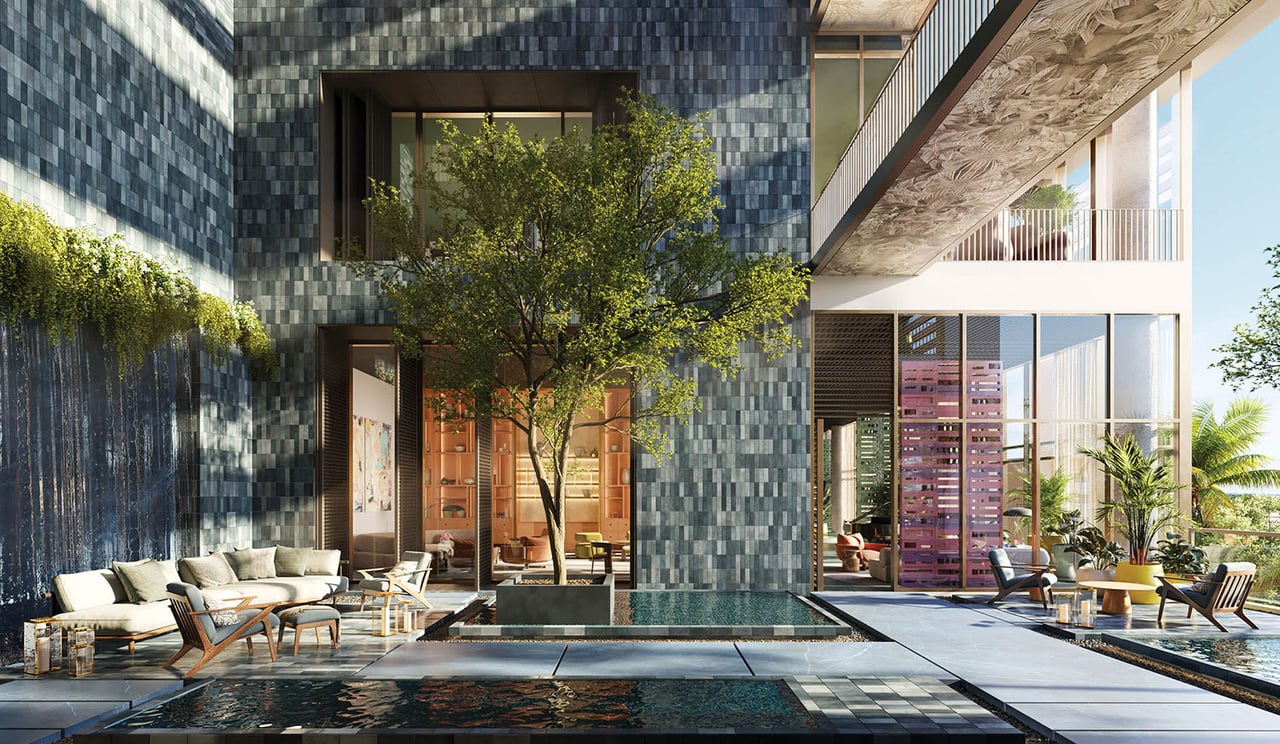 Condominium courtyard with reflecting pool, cascading water feature, and furnished outdoor lounge areas.