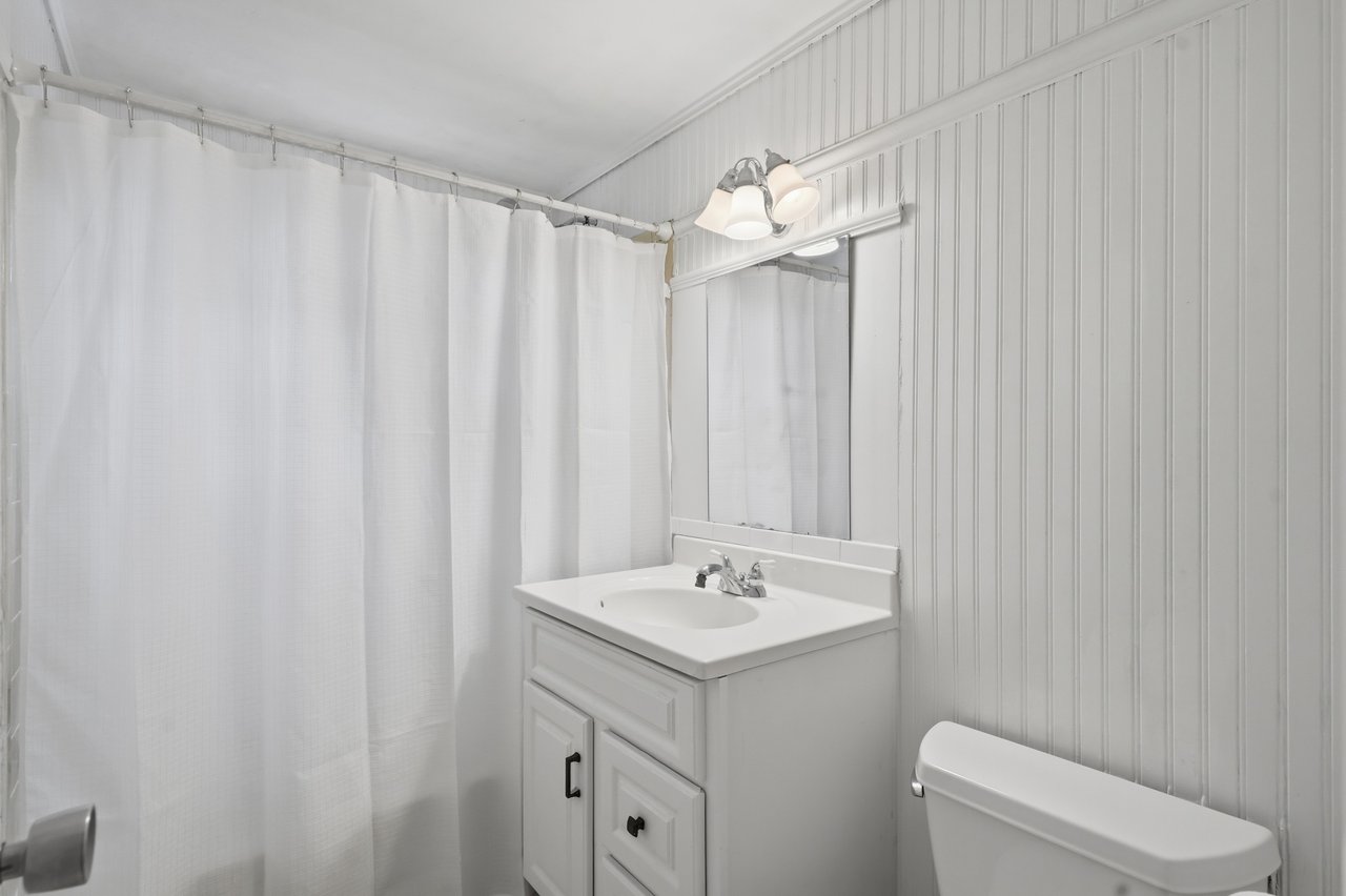 Private full bath featuring shower, sink, and toilet