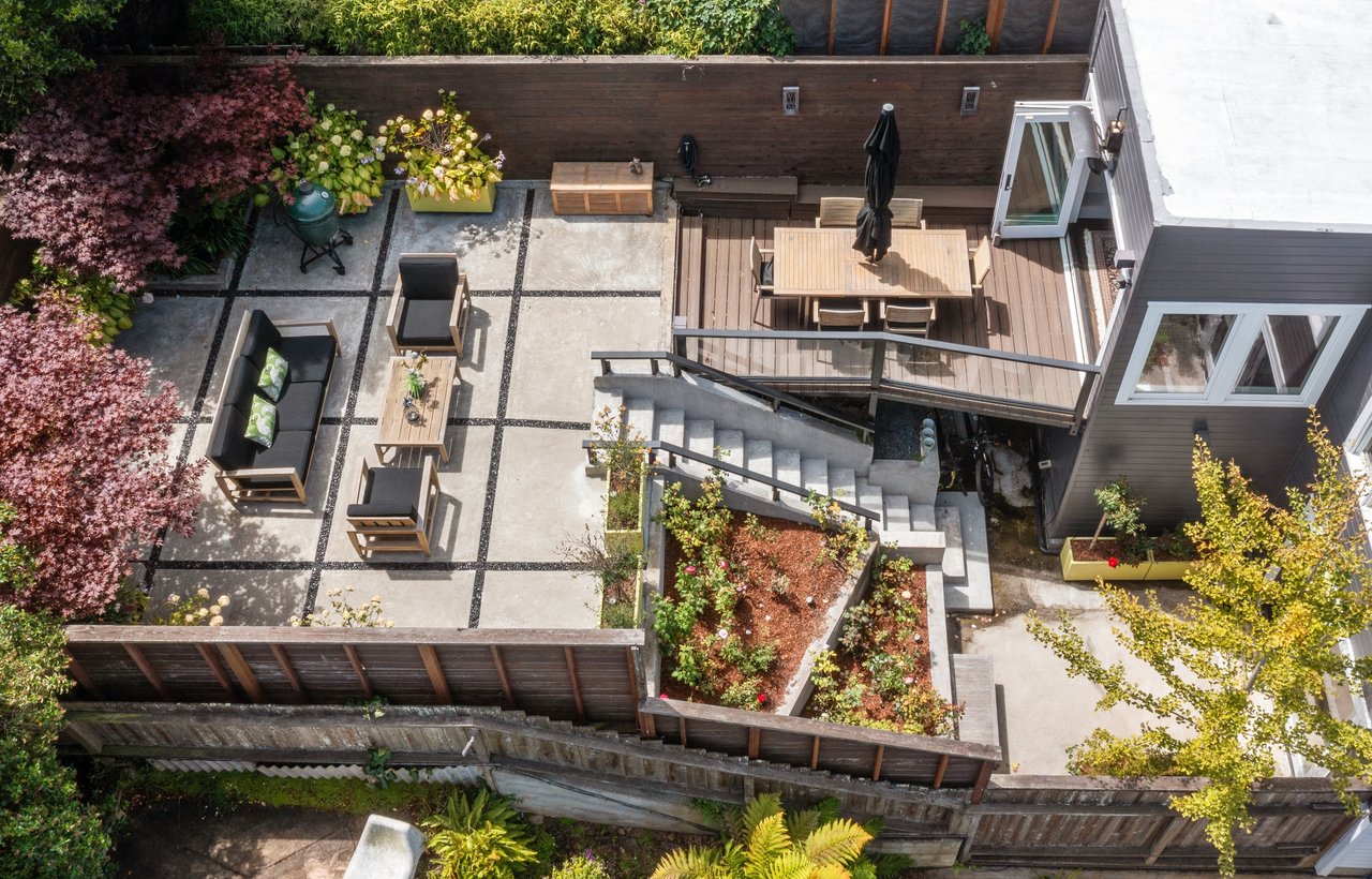 A well-designed San Francisco backyard with a modern patio and greenery, highlighting the results of a permitted home improvement project in the city