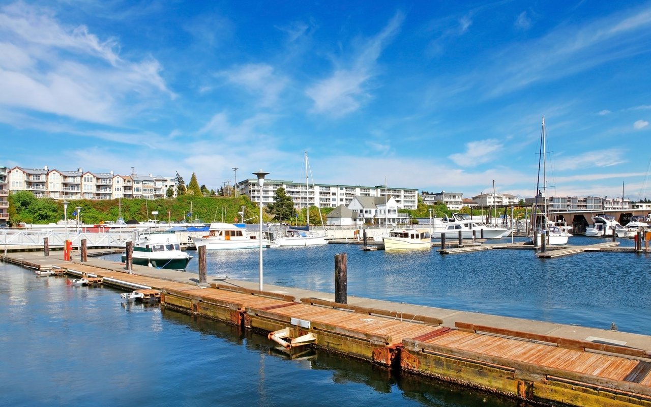 Des Moines marina with boats along the docks and waterfront condominiums.