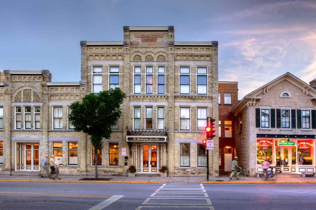 Historic Washington House Inn building in downtown Cedarburg with pedestrians walking along the street.
