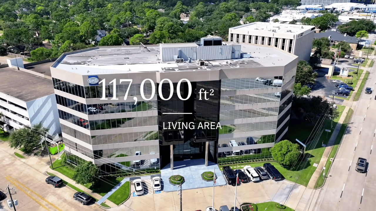 Aerial view of a glass office building with 117,000 square feet of living area.