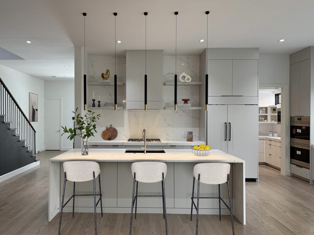 Contemporary kitchen with large island, pendant lighting, and high-end appliances, designed by S&R Development on Del Norte