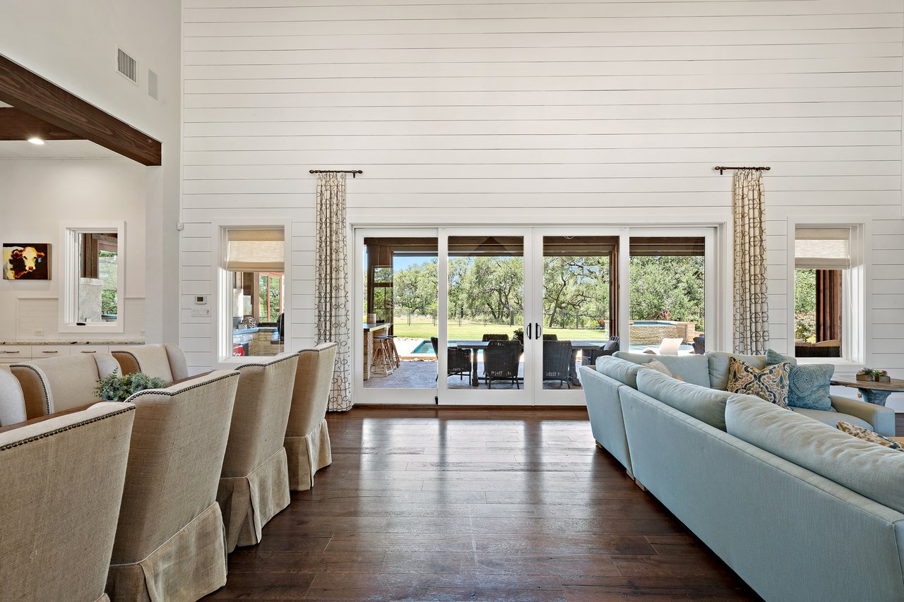 Dining area at 335 Winning Colors opening through sliding glass doors to the covered patio and pool beyond.