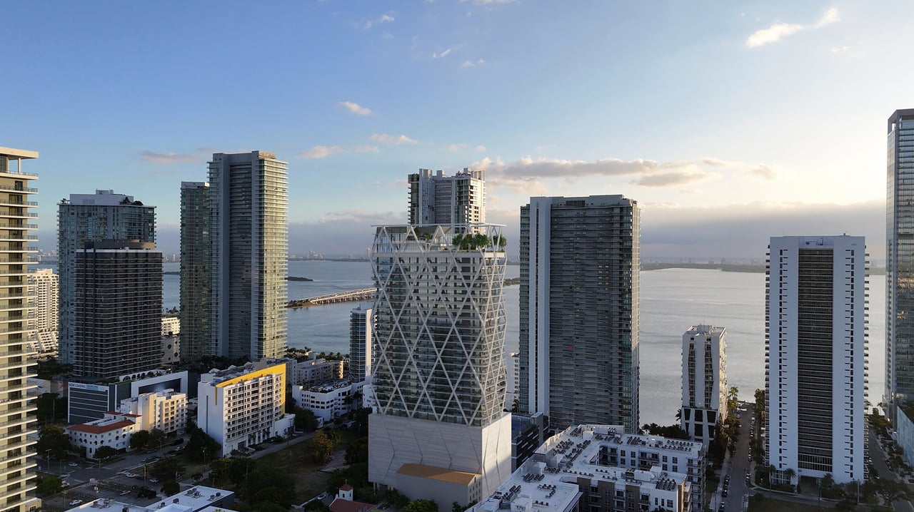 Miami skyline and bay with a prominent tower featuring a white diagonal lattice exterior.