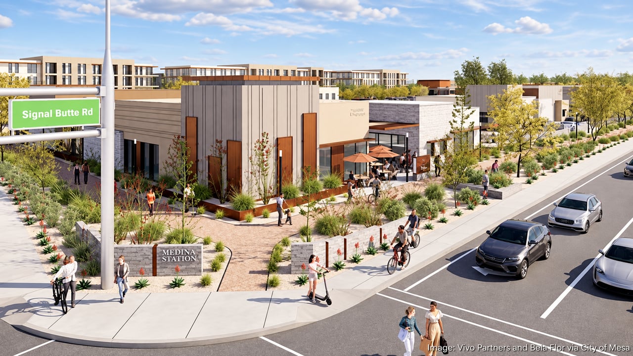 Medina Station streetscape with modern storefronts, landscaped walkways, cyclists, and cars.