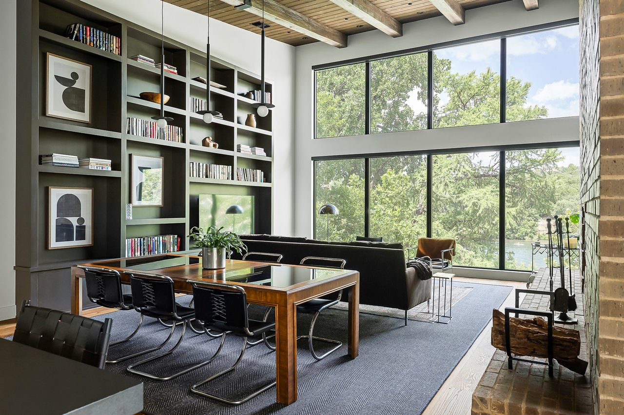 Great room and dining area with built-in bookshelves and exposed beams, furnished by Liz MacPhail Interiors. Kelley Design Group design, Pecan Valley Custom Homes construction. Lake Austin waterfront at 2403 Big Horn Drive, Austin.
