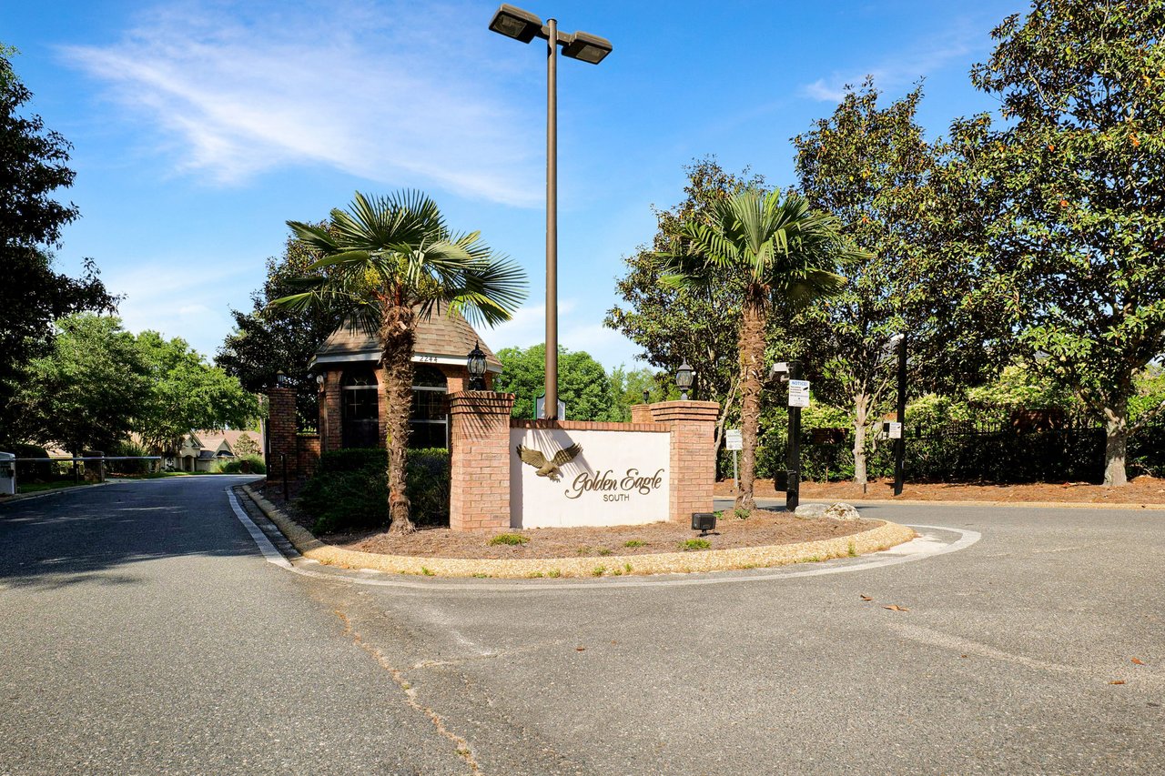 A ground-level view of the entrance sign for "Golden Eagle," marking the entrance to the community.