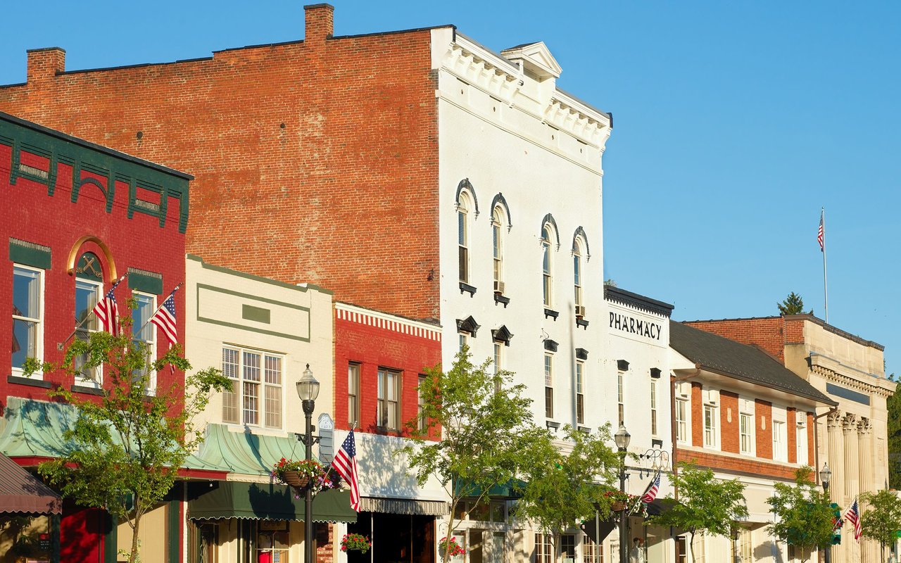 Historic Chagrin Falls storefronts, including a white pharmacy building and colorful brick facades.