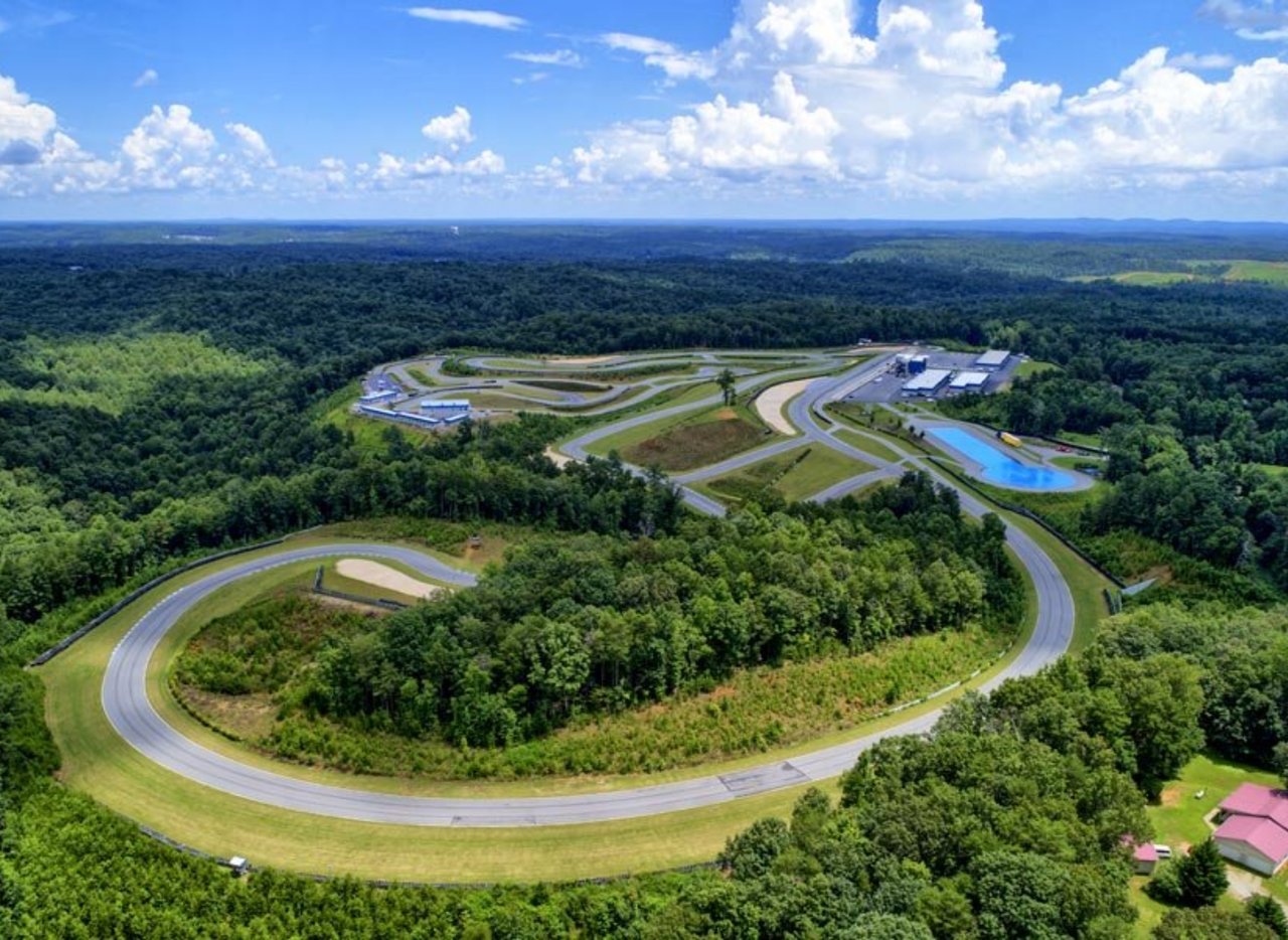 Winding motorsports track surrounded by dense woodland in Dawsonville, Georgia.