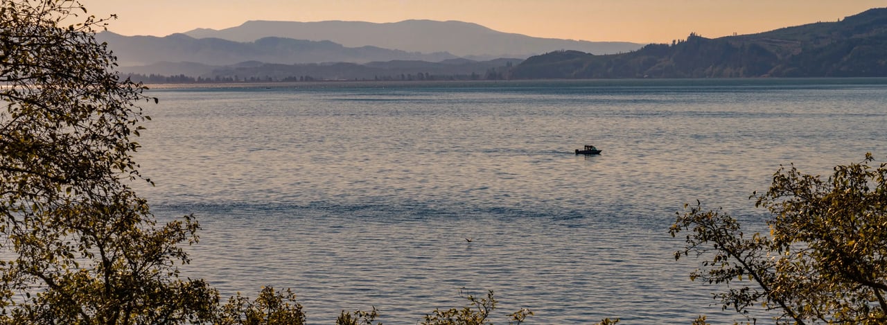 Lone fishing boat in the bay viewed from Bay City Oregon