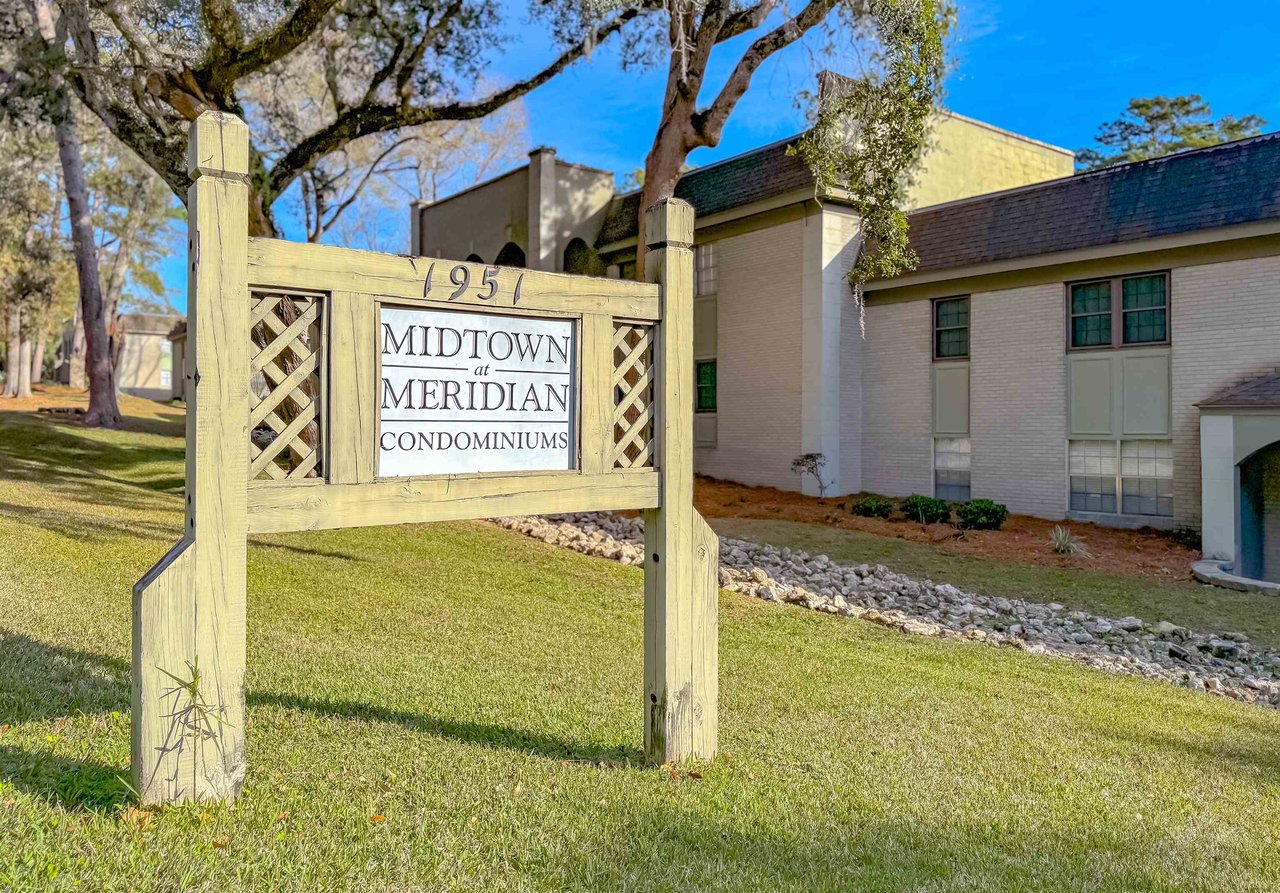 Wildwood Apartments sign prominently displayed in front of the building, showcasing the property’s name and location.