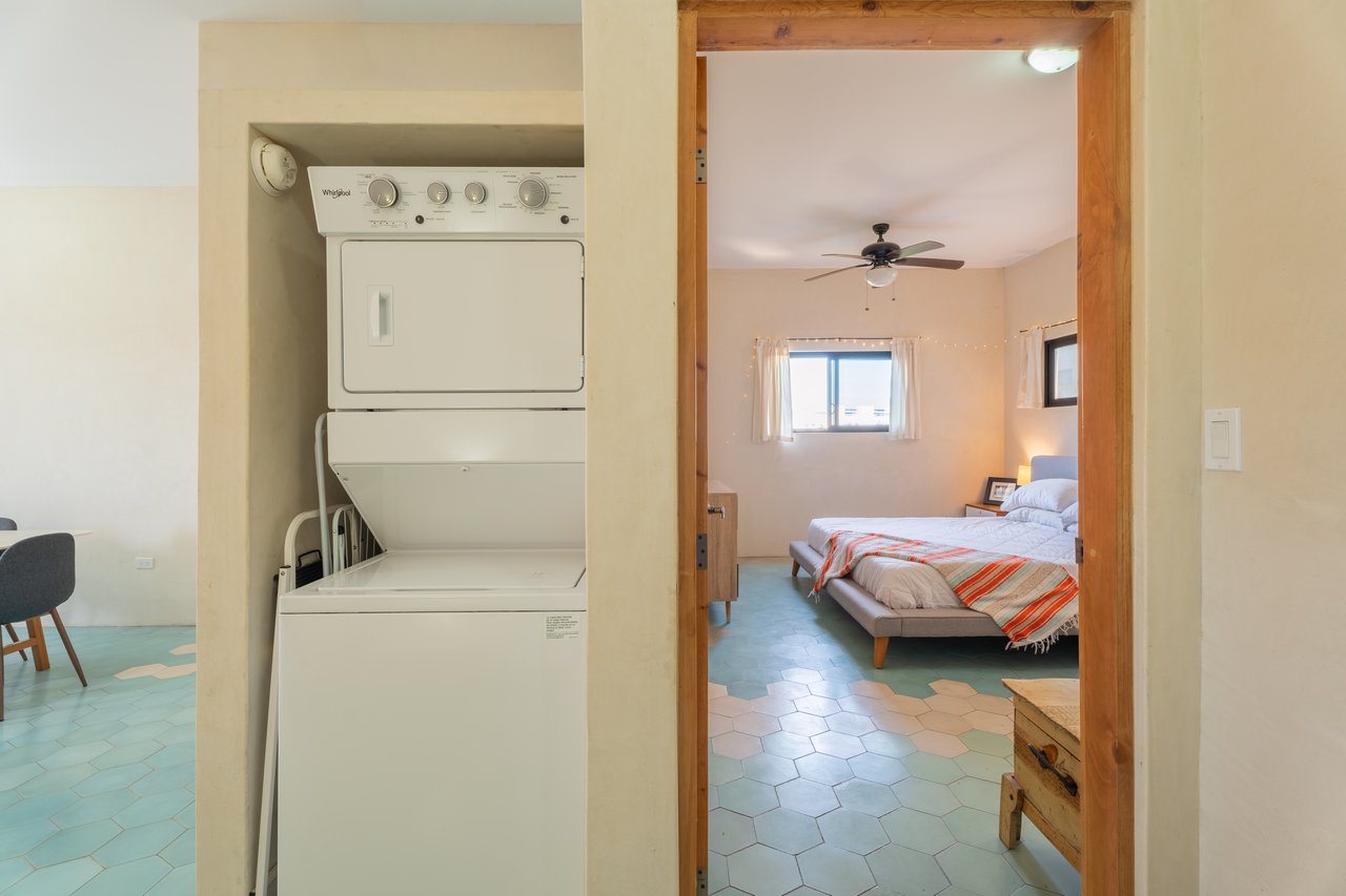 Laundry room and primary bedroom at The Studio House in Villas de Cerritos with functional layout in Cerritos, Baja California Sur.